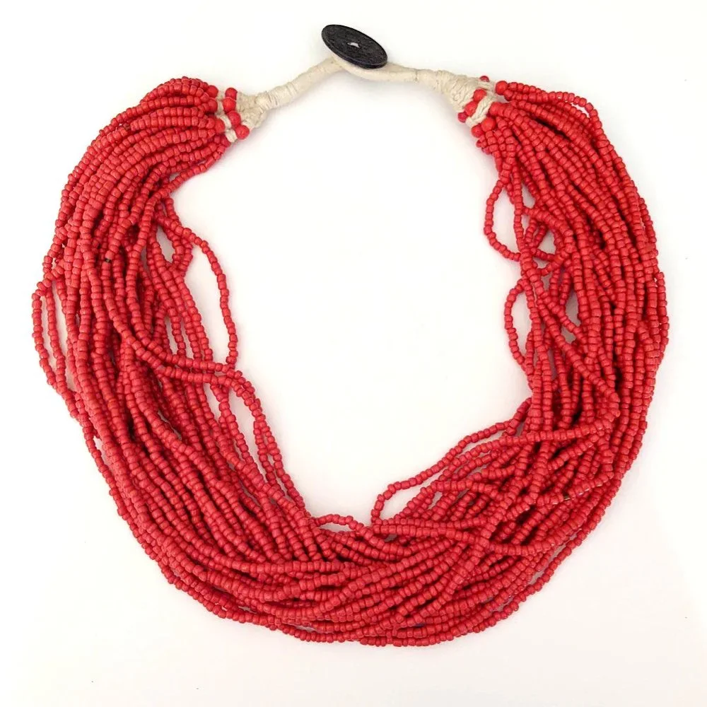 Layered orange beaded necklace with old coin toggle closure